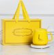 Electric mug warmer with cup, lid and spoon, yellow